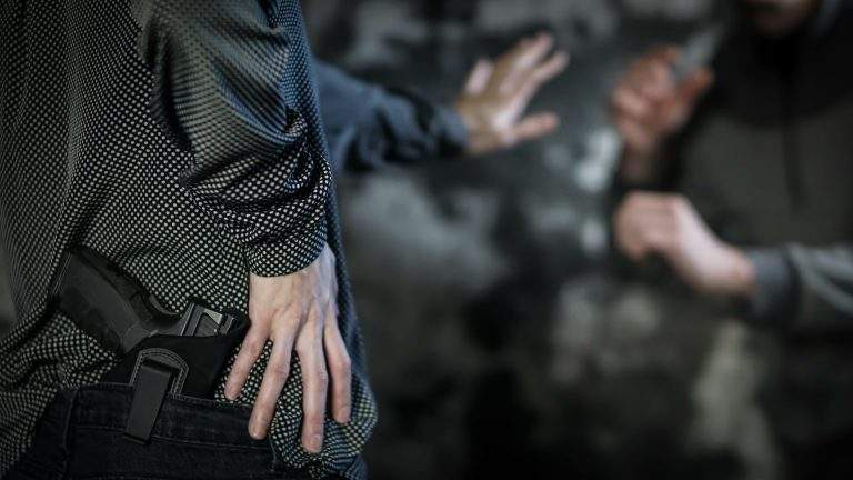 Woman reaching for handgun to defend against attacker. Women’s p