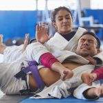 Cropped shot of two young martial artists practicing jiu jitsu in the gym.