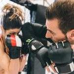 mma training. couple making sparring in the mma cage. concept about fighting, fitness and sport